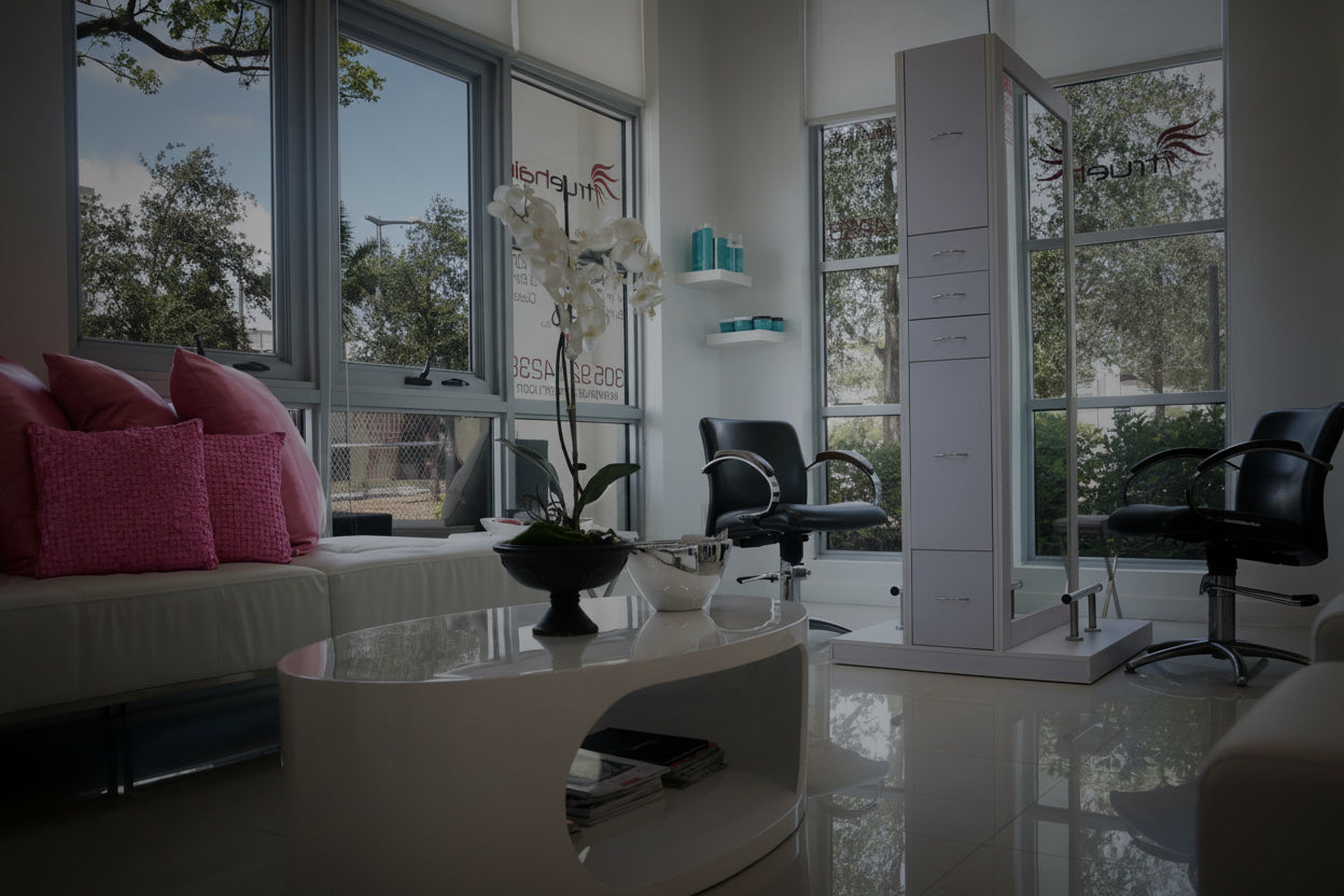 Modern living room with large windows, furniture, and decor.